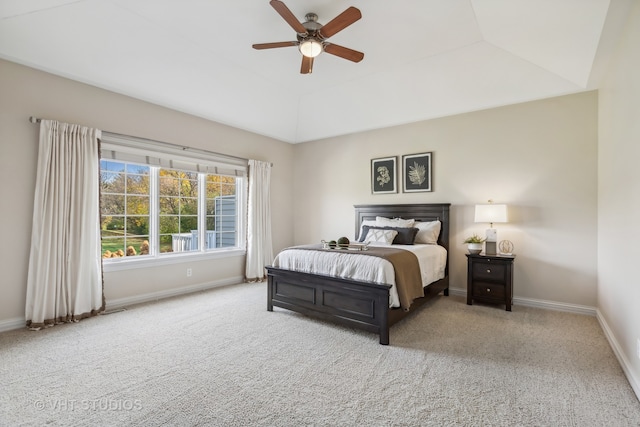 bedroom featuring ceiling fan, lofted ceiling, and light carpet