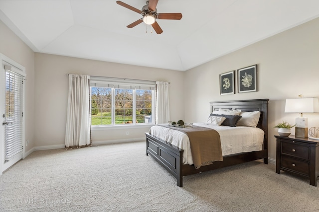 bedroom featuring a tray ceiling, ceiling fan, light colored carpet, and lofted ceiling