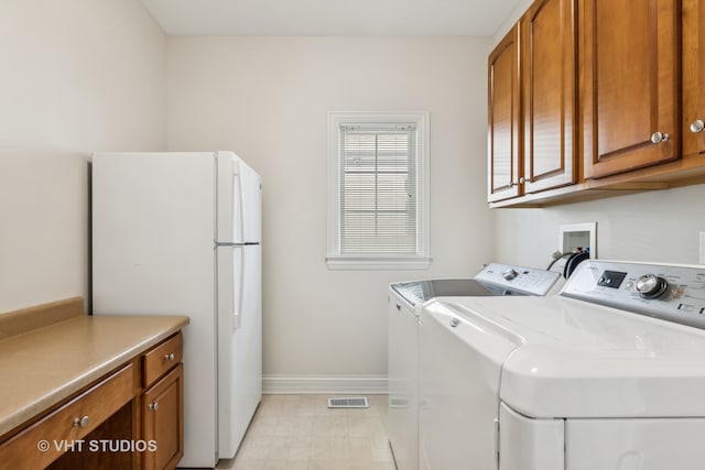 laundry room with cabinets and washing machine and dryer