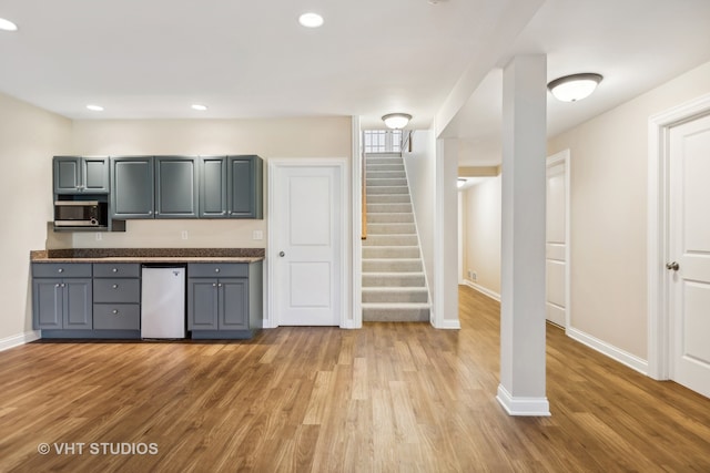 kitchen with white fridge, light hardwood / wood-style flooring, and gray cabinetry