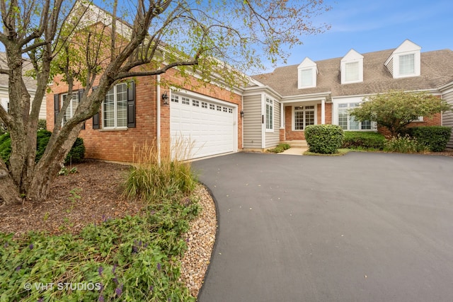 cape cod home with a garage