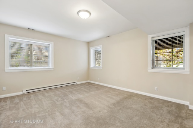 unfurnished room with light carpet and a baseboard heating unit