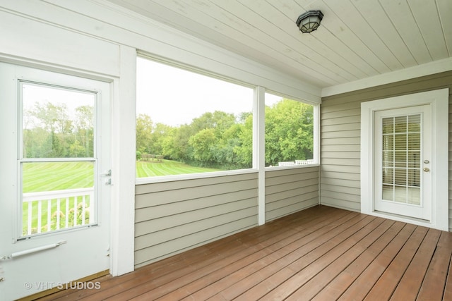 unfurnished sunroom with wood ceiling and a healthy amount of sunlight