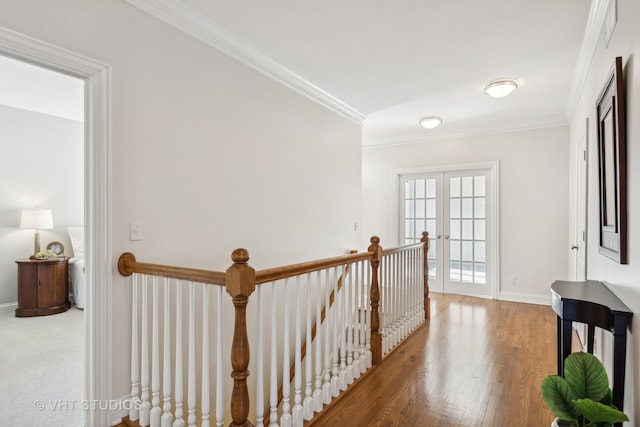 corridor with french doors, hardwood / wood-style flooring, and ornamental molding