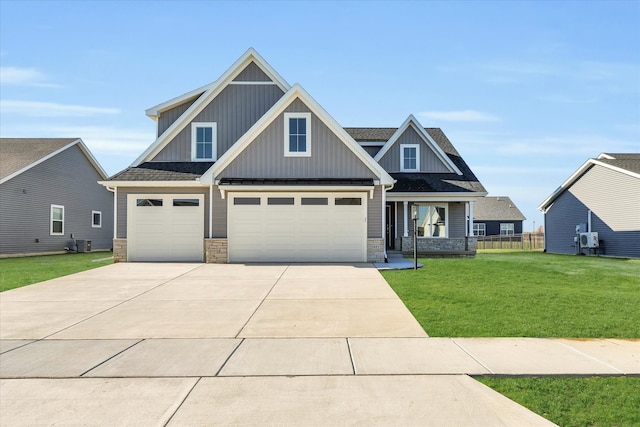 craftsman inspired home with a front yard, a garage, and covered porch