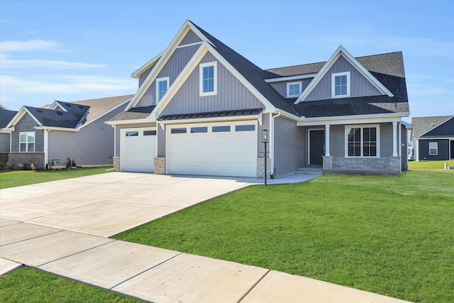 craftsman inspired home featuring a garage and a front lawn