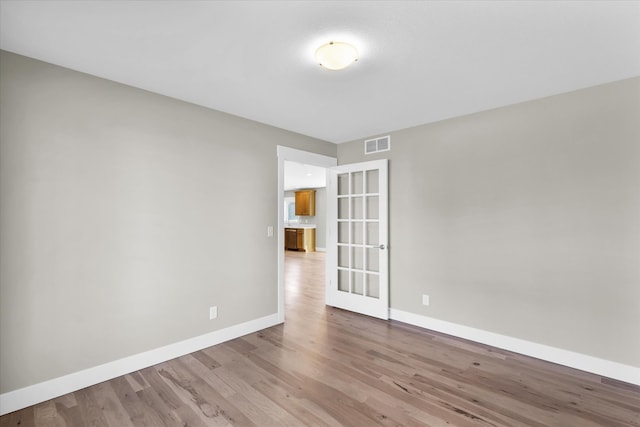 unfurnished room with light hardwood / wood-style floors