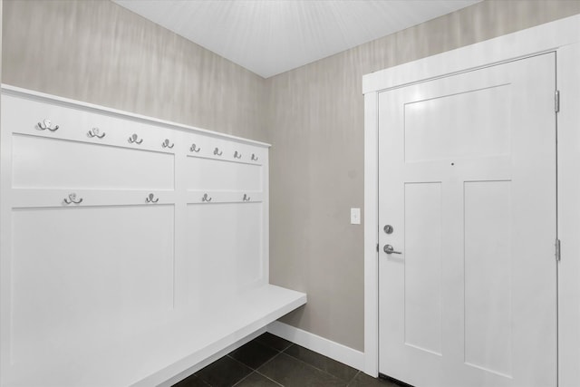 mudroom with dark tile patterned flooring