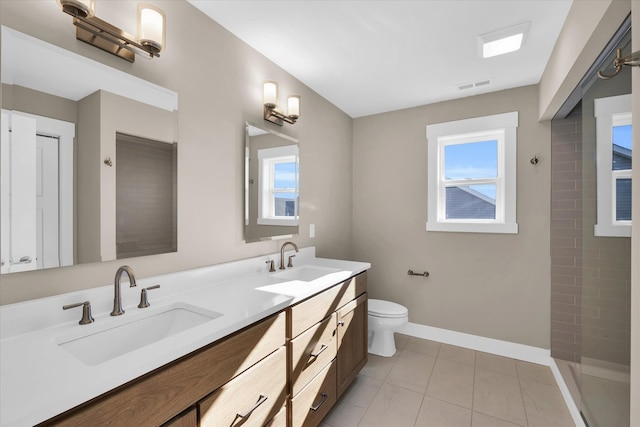 bathroom with tile patterned floors, vanity, a tile shower, and toilet