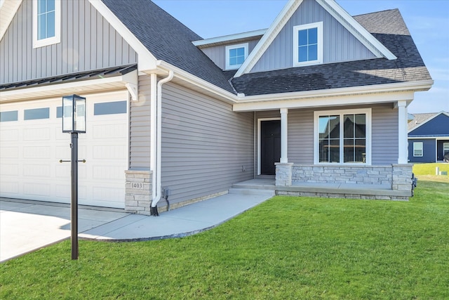 craftsman inspired home with a garage and a front yard