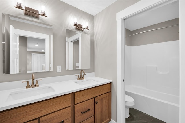 full bathroom featuring bathtub / shower combination, vanity, and toilet