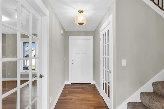 doorway with hardwood / wood-style floors and french doors