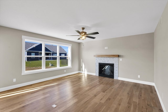 unfurnished living room with hardwood / wood-style floors and ceiling fan