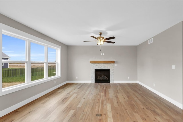 unfurnished living room featuring ceiling fan and light hardwood / wood-style floors