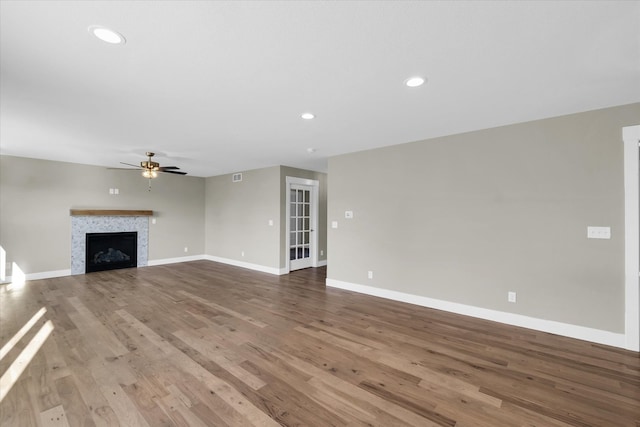 unfurnished living room featuring hardwood / wood-style floors and ceiling fan