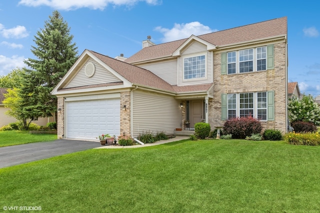 view of front of house with a front yard and a garage