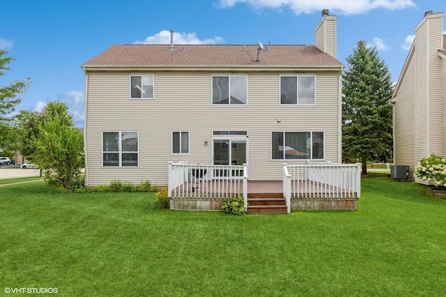 rear view of property with cooling unit, a deck, and a yard