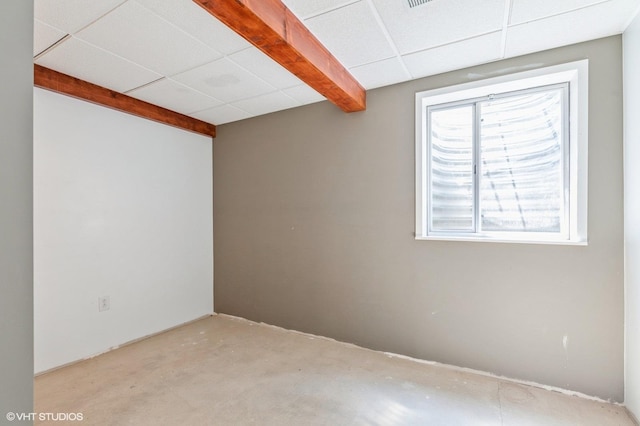 basement with a paneled ceiling and plenty of natural light