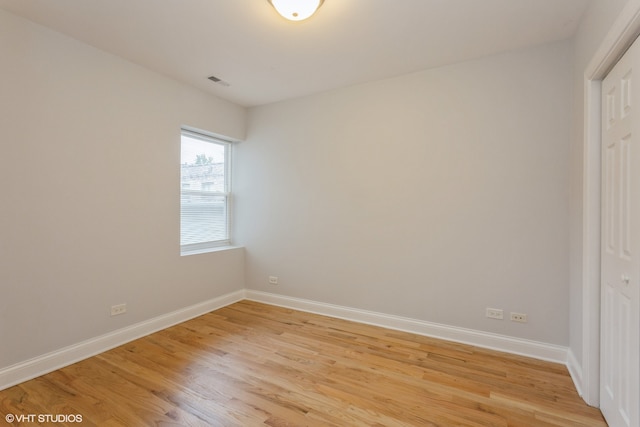 unfurnished bedroom with a closet and light hardwood / wood-style flooring