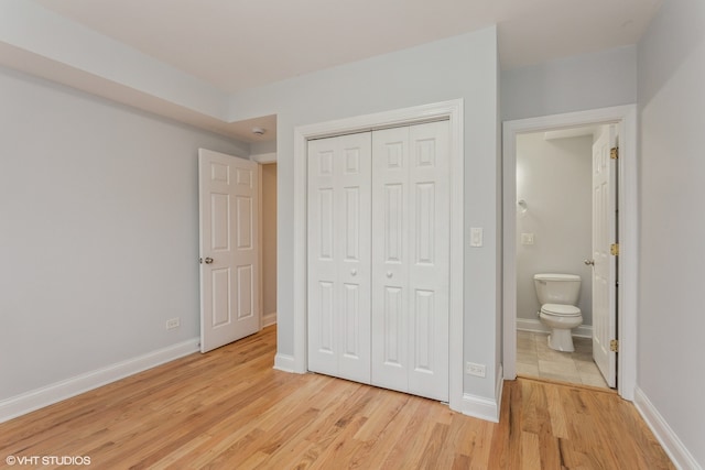 unfurnished bedroom featuring light hardwood / wood-style floors and a closet