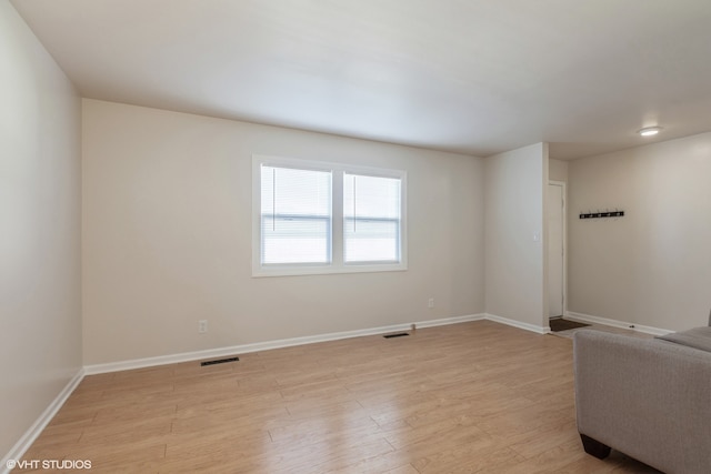 spare room featuring light hardwood / wood-style flooring