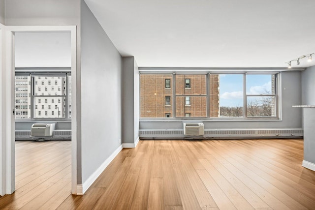 unfurnished living room featuring light hardwood / wood-style floors and a wall mounted AC