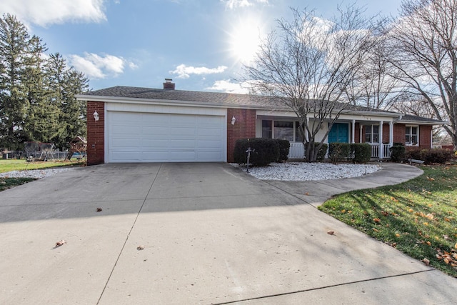 single story home with a porch and a garage