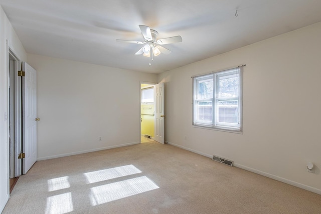 unfurnished bedroom with light colored carpet and ceiling fan