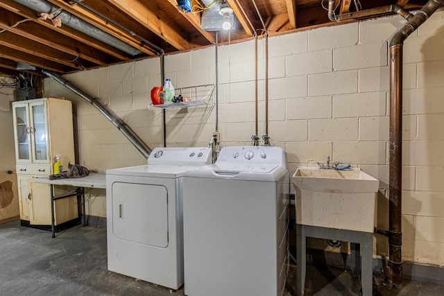 washroom featuring washing machine and dryer and sink