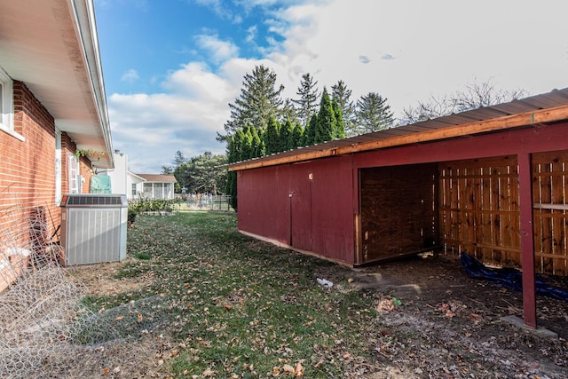 view of yard featuring an outbuilding and central air condition unit