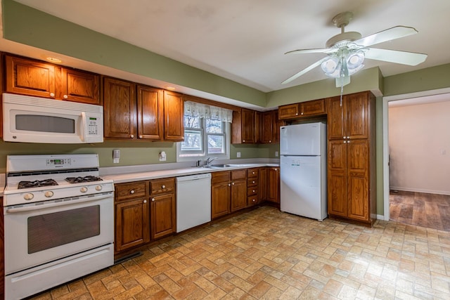 kitchen with white appliances, ceiling fan, and sink