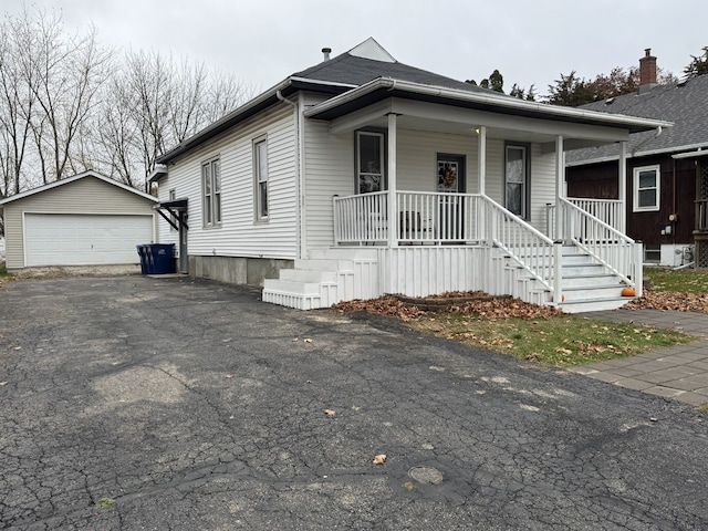 view of front of home with an outbuilding, a garage, and covered porch