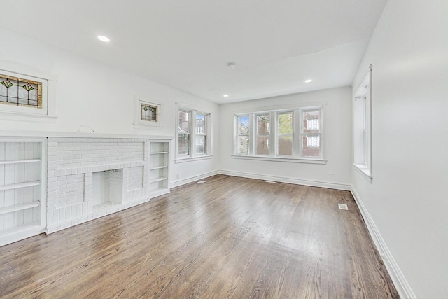 5092 W Monroe St, Chicago, IL 60644 - unfurnished living room with wood finished floors, baseboards, recessed lighting, and a brick fireplace