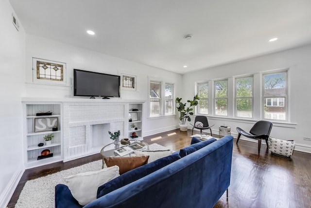 5092 W Monroe St, Chicago, IL 60644 - living room with baseboards, wood finished floors, a fireplace, and recessed lighting