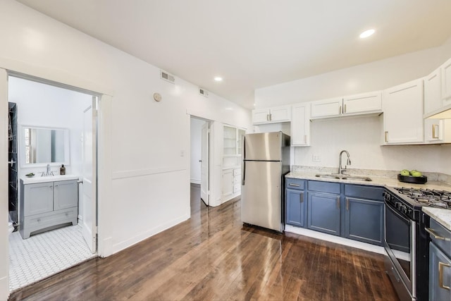 5092 W Monroe St, Chicago, IL 60644 - kitchen featuring stainless steel appliances, a sink, dark wood-type flooring, white cabinetry, and recessed lighting