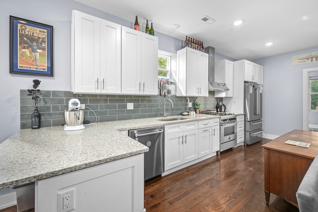 kitchen with white cabinets, appliances with stainless steel finishes, a wealth of natural light, and sink