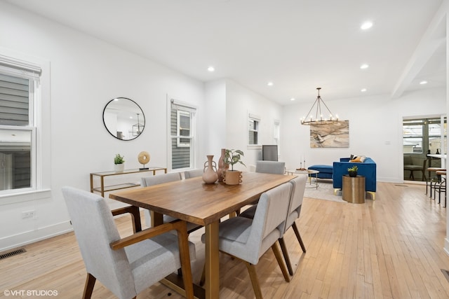 dining area featuring a chandelier and light hardwood / wood-style flooring