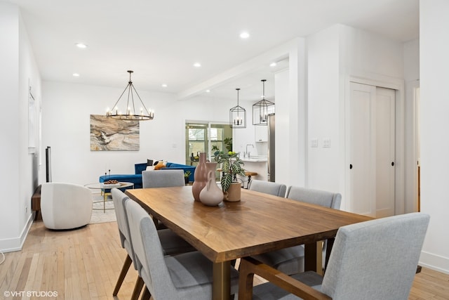 dining area with light hardwood / wood-style flooring and sink