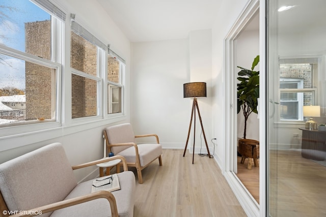 living area with a wealth of natural light and light wood-type flooring