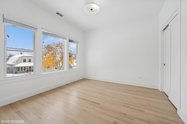 unfurnished bedroom with a closet and light hardwood / wood-style flooring