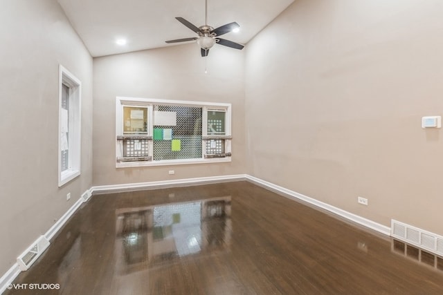 empty room with hardwood / wood-style flooring, high vaulted ceiling, and ceiling fan