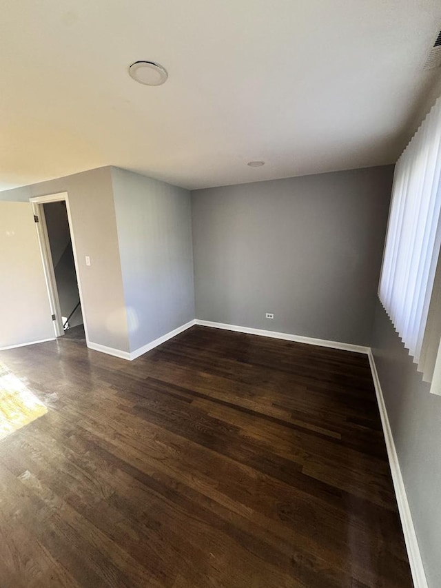 empty room with dark hardwood / wood-style floors