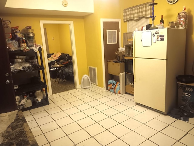 kitchen featuring white fridge and light tile patterned floors