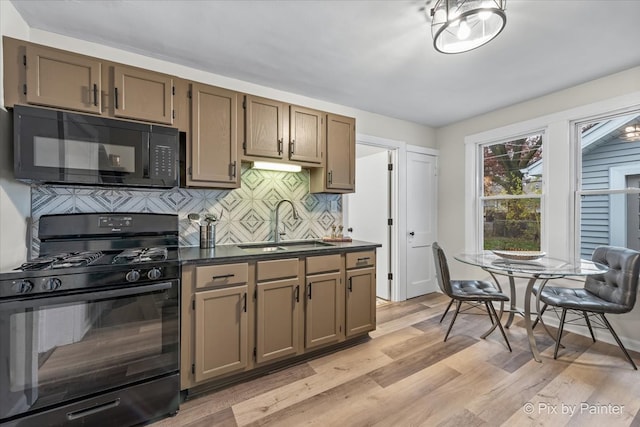 kitchen featuring decorative backsplash, sink, black appliances, and light wood-type flooring