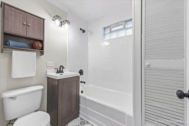 full bathroom with tiled shower / bath, vanity, and toilet