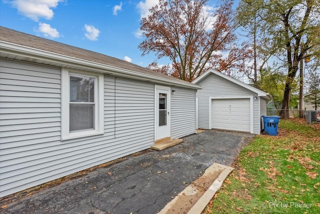 exterior space with an outbuilding and a garage