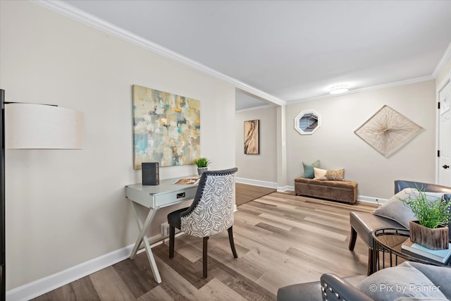 home office with ornamental molding and light hardwood / wood-style flooring