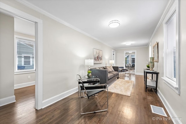 living room with crown molding and dark wood-type flooring