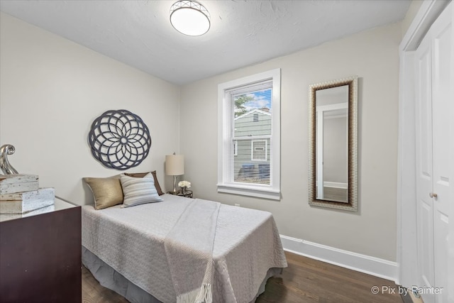 bedroom featuring dark hardwood / wood-style floors and a closet