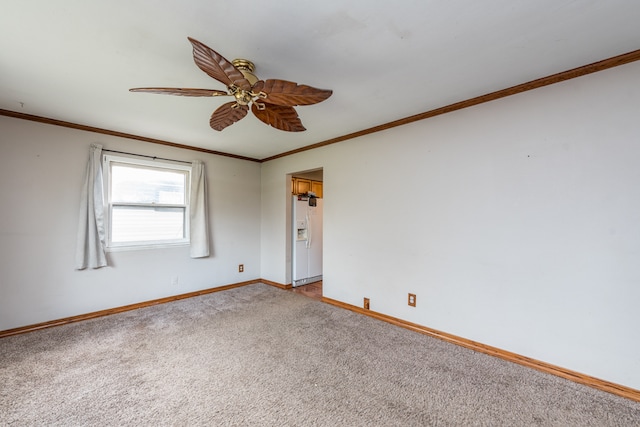 carpeted empty room featuring ceiling fan and crown molding